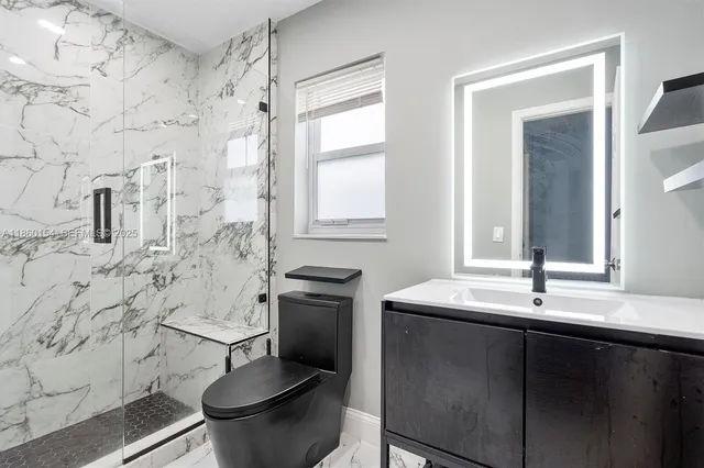 a bathroom with a toilet sink and mirror