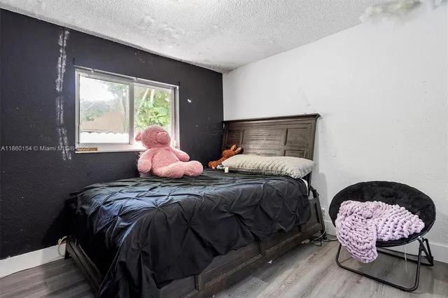 a bedroom with a bed chair and window