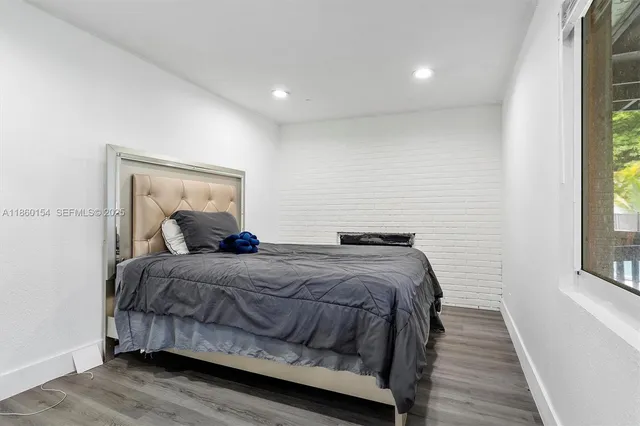 a bedroom with a bed and windows