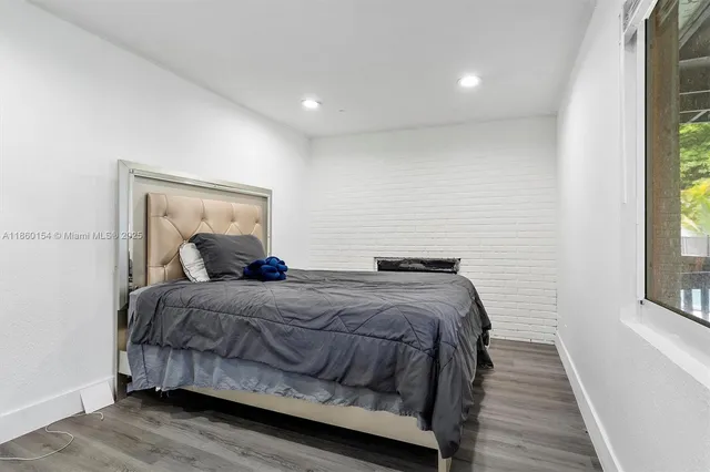 a bedroom with a bed and windows