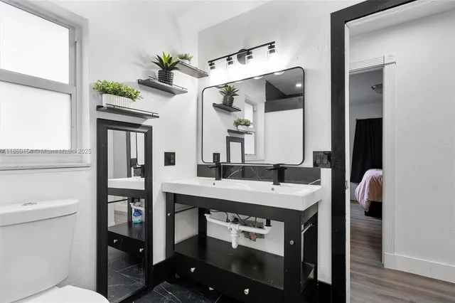 a view of living room with furniture and wooden floor