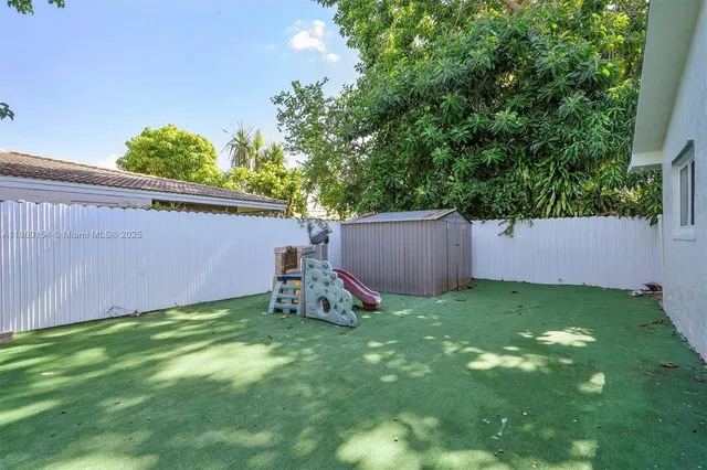 a view of an house with backyard and porch