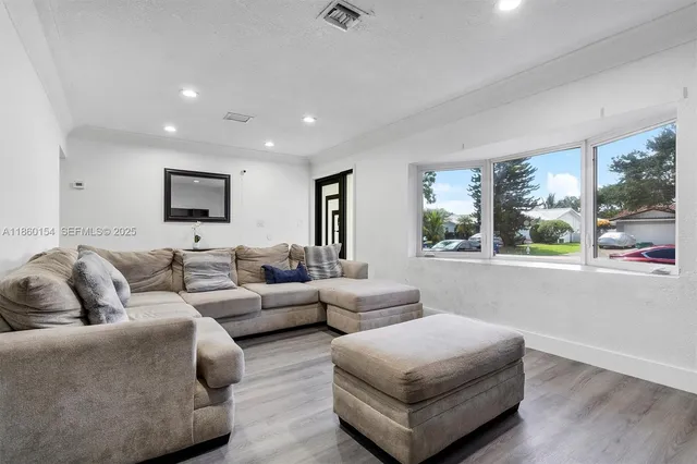 a living room with furniture and a large window