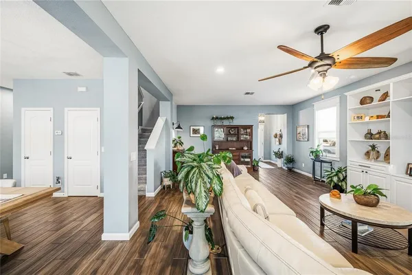 a view of a livingroom with furniture and a ceiling fan