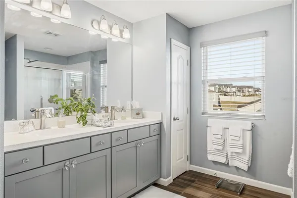 a bathroom with a shower and a sink