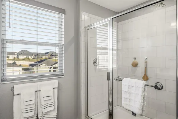 a room with furniture a chandelier a mirror and a window