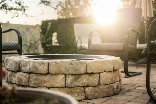 a bed with white sheets and pillows