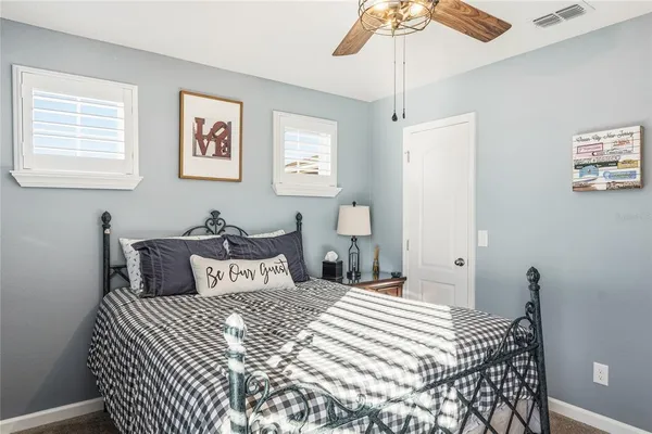 a view of a backyard with couches under an umbrella