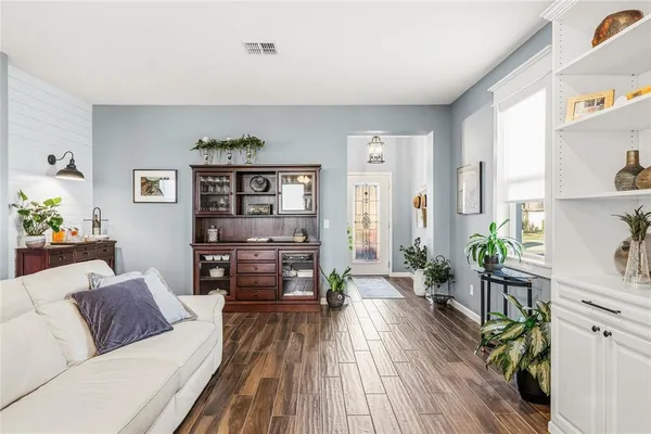 a living room with furniture and wooden floor