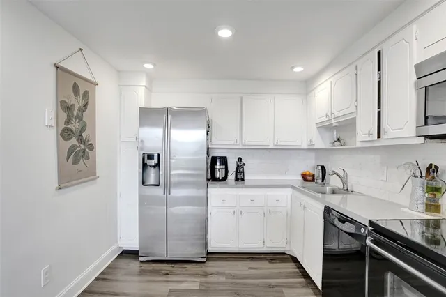 a kitchen with a sink stainless steel appliances and cabinets