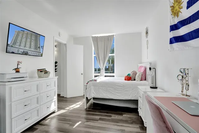 a bedroom with a bed and a dresser