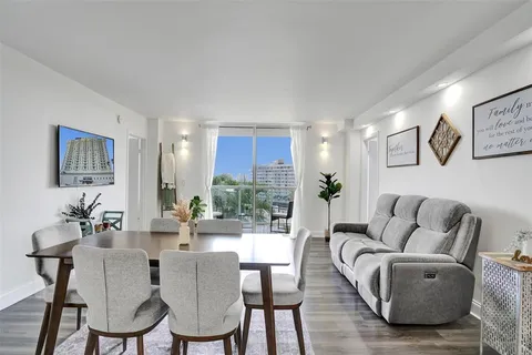 a living room with furniture potted plant and a window