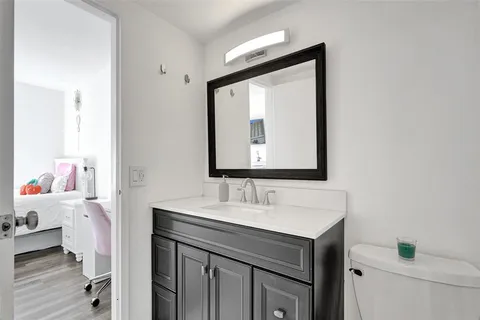 a bathroom with a sink vanity and a mirror