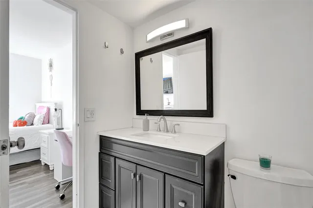 a bathroom with a sink vanity and a mirror
