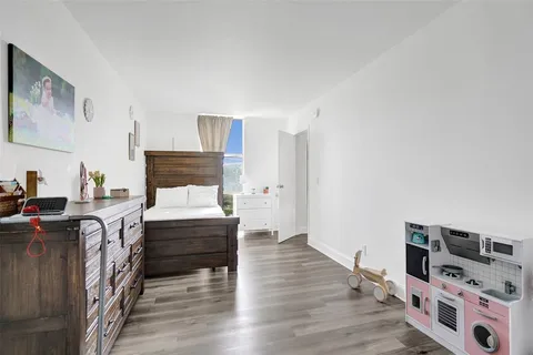 a bedroom with furniture and a wooden floor