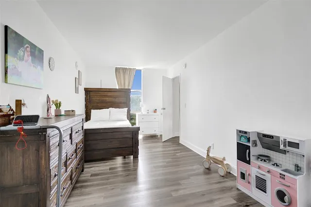 a bedroom with furniture and a wooden floor