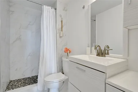a bathroom with a sink toilet and shower