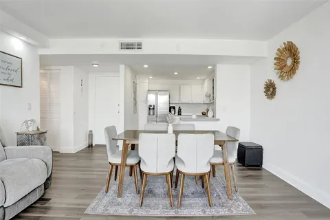 a dining room with furniture and wooden floor