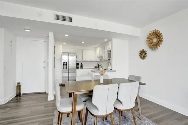 a dining room with furniture and wooden floor
