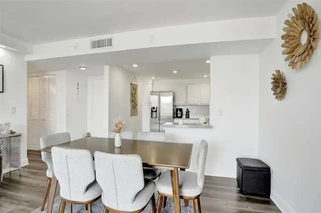 a dining room with furniture and a view of kitchen