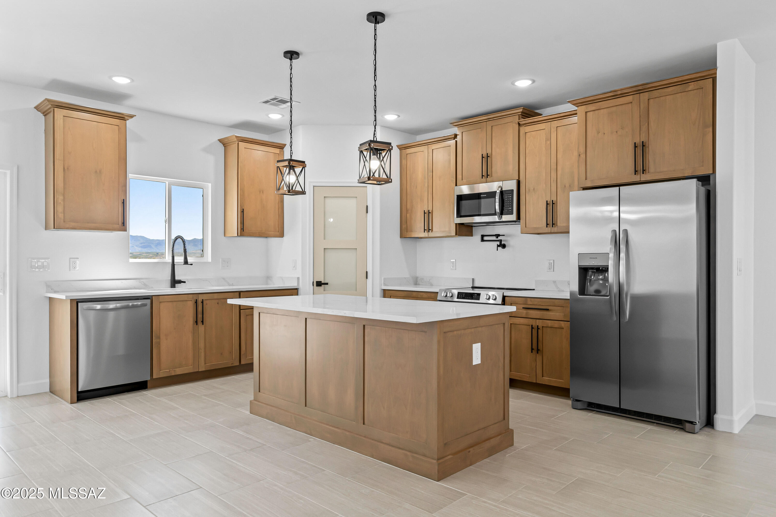 1674 Calle Cabo Rio Rico, AZ 85648 - Photo 11 of 33 a kitchen with stainless steel appliances granite countertop a refrigerator a sink a stove a microwave and island