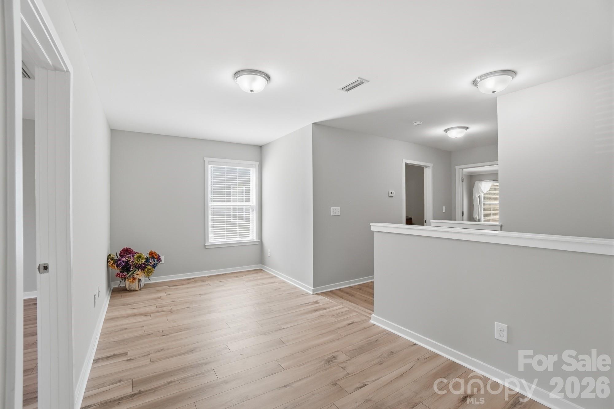 2153 Bluebell Way Tega Cay, SC 29708 - Photo 35 of 48 wooden floor in an empty room with a window