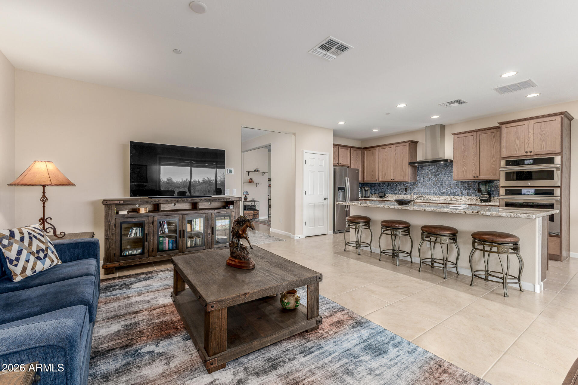 18325 East Spring Valley Court Rio Verde, AZ 85263 - Photo 12 of 50 a living room with stainless steel appliances kitchen island granite countertop a stove a sink a refrigerator and a microwave