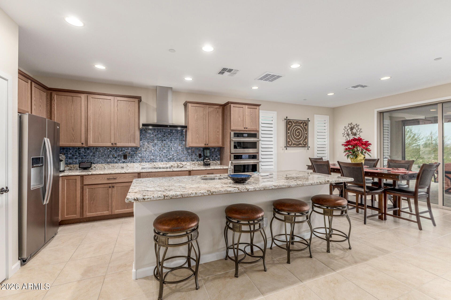 18325 East Spring Valley Court Rio Verde, AZ 85263 - Photo 14 of 50 a kitchen with cabinets and chairs