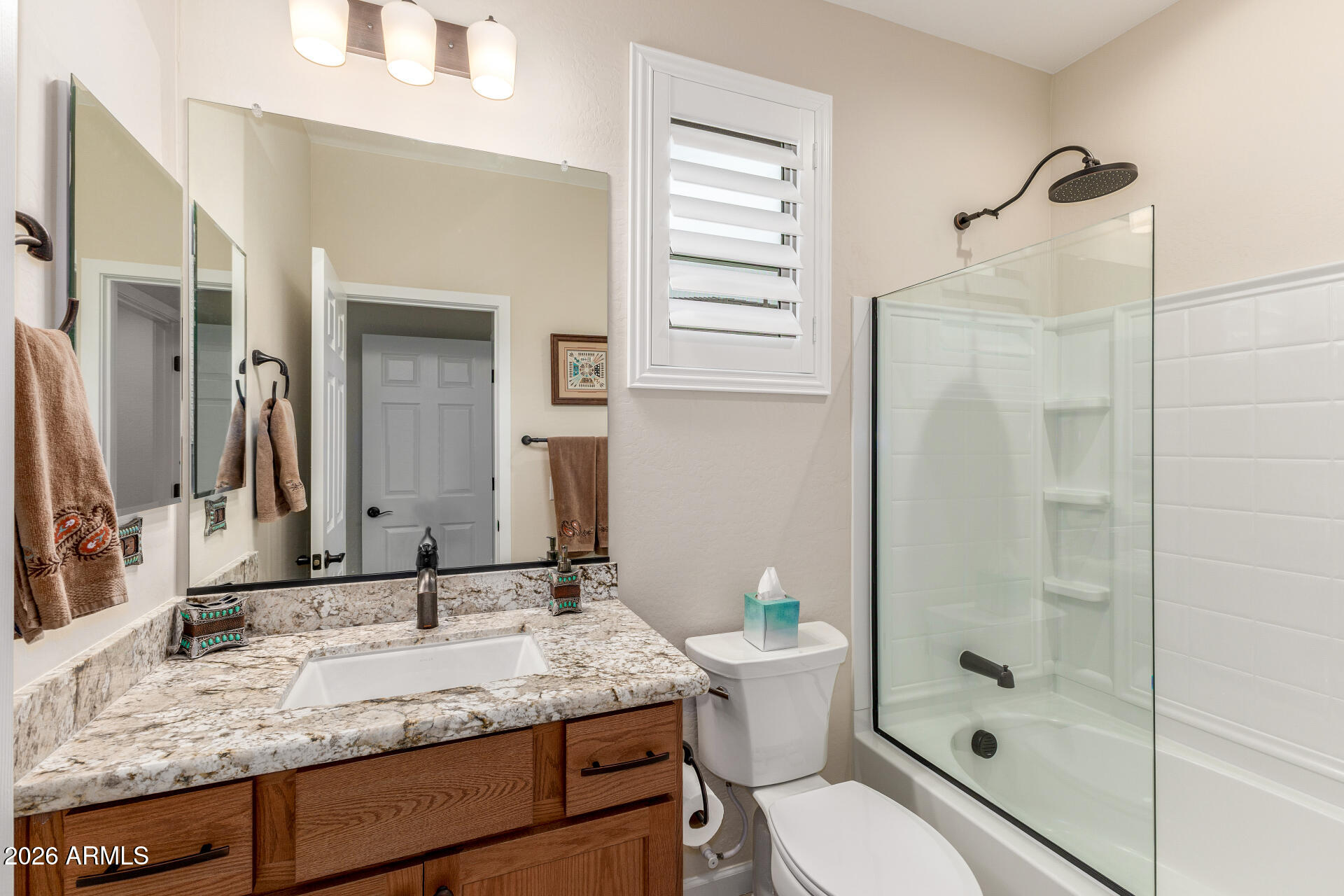 18325 East Spring Valley Court Rio Verde, AZ 85263 - Photo 32 of 50 a bathroom with a granite countertop sink a toilet a mirror and shower