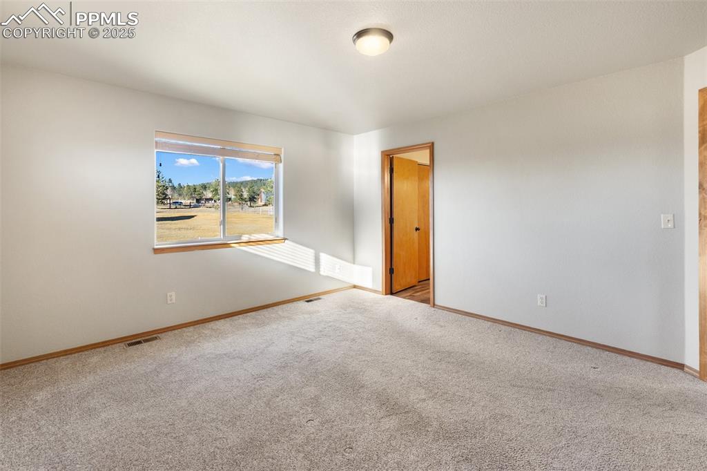 1380 Rampart Range Road Woodland Park, CO 80863 - Photo 11 of 30 an empty room with windows and closet