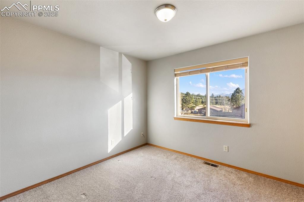 1380 Rampart Range Road Woodland Park, CO 80863 - Photo 13 of 30 an empty room with windows