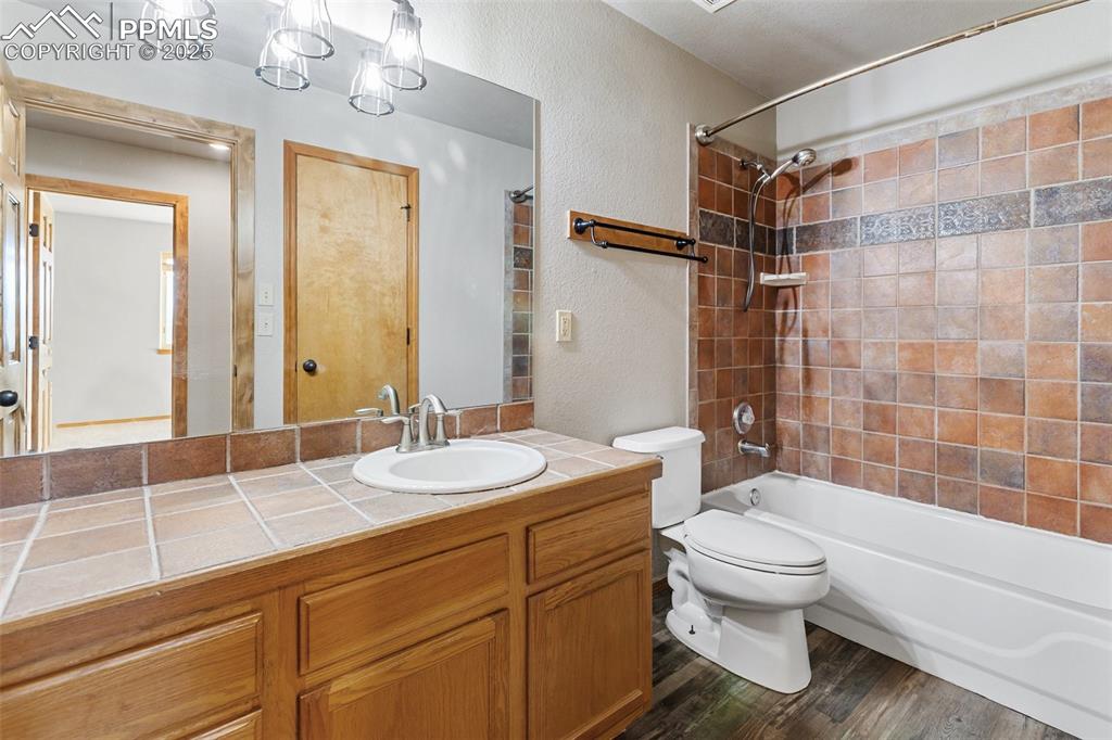 1380 Rampart Range Road Woodland Park, CO 80863 - Photo 17 of 30 a bathroom with a sink a toilet and shower