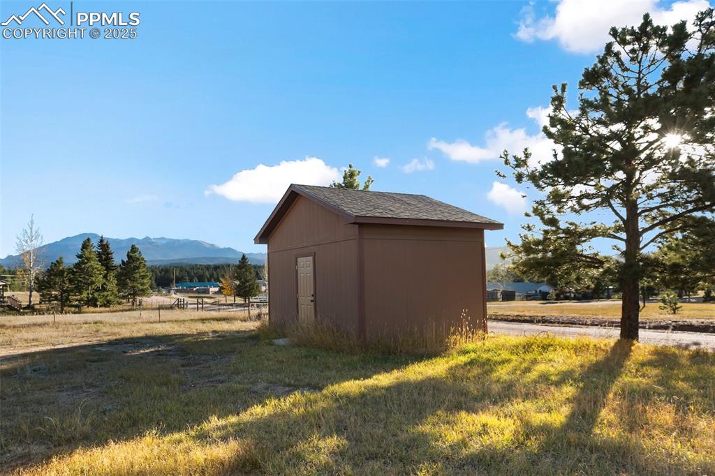 1380 Rampart Range Road Woodland Park, CO 80863 - Photo 26 of 30 a view of a house with a yard