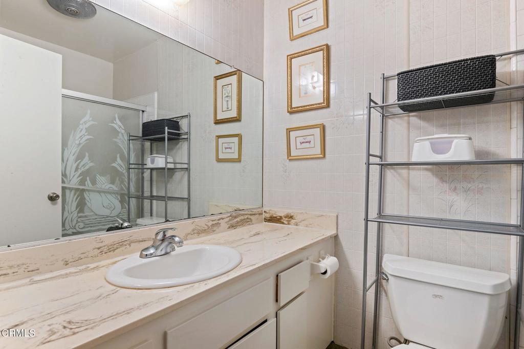 2606 Rudder Avenue Port Hueneme, CA 93041 - Photo 11 of 16 a bathroom with a granite countertop sink toilet and shower