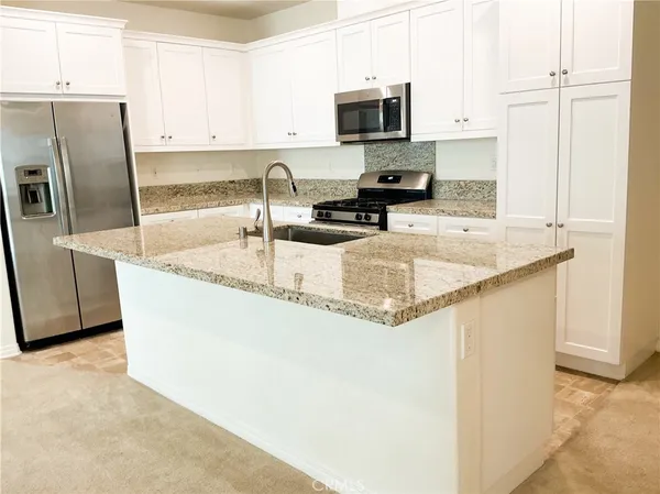 a view of an empty room with closet and a window