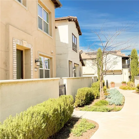 a view of a kitchen with a sink and a refrigerator in it