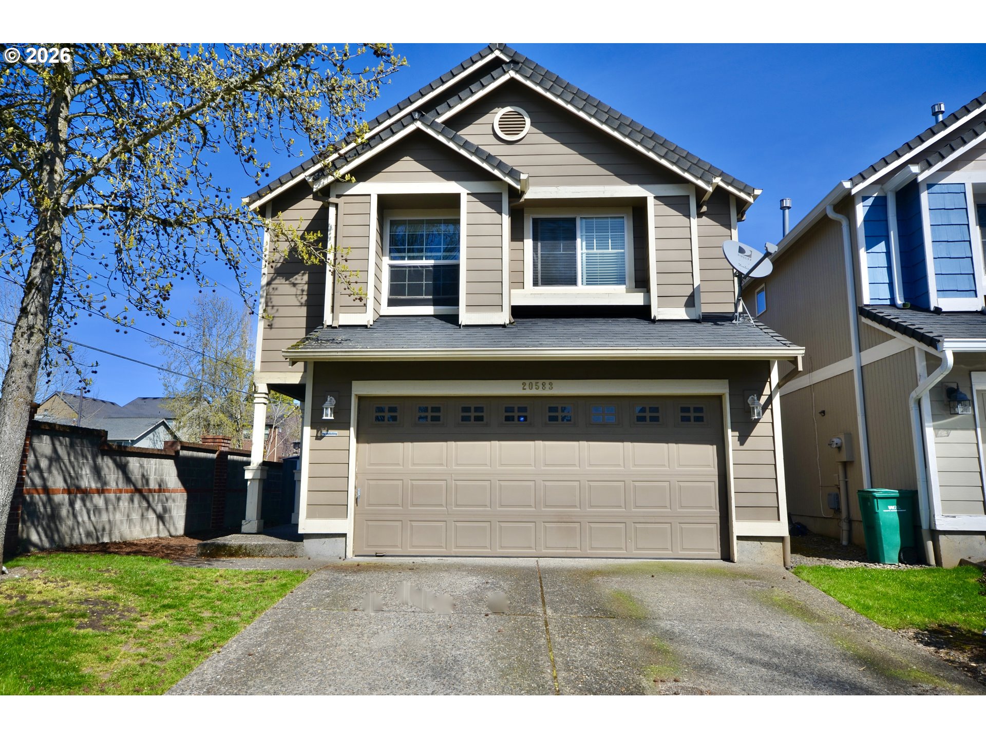 20583 Southwest Tesoro Court Beaverton, OR 97003 - Photo 2 of 28 a front view of a house with a yard and garage