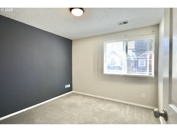 a backyard of a house with wooden fence