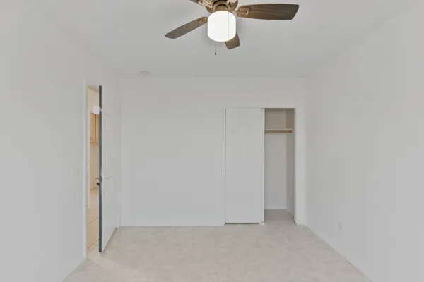 a view of a room with a fan and a window