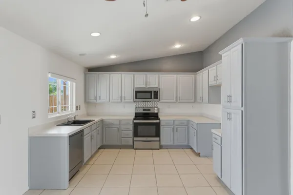a kitchen with a sink stainless steel appliances and cabinets