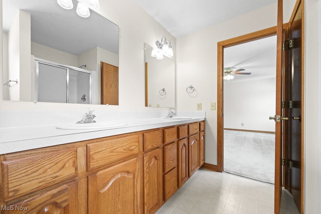 4808 Sherman Road Kent, OH 44240 - Photo 39 of 50 Full bathroom with double vanity, a stall shower, and ceiling fan