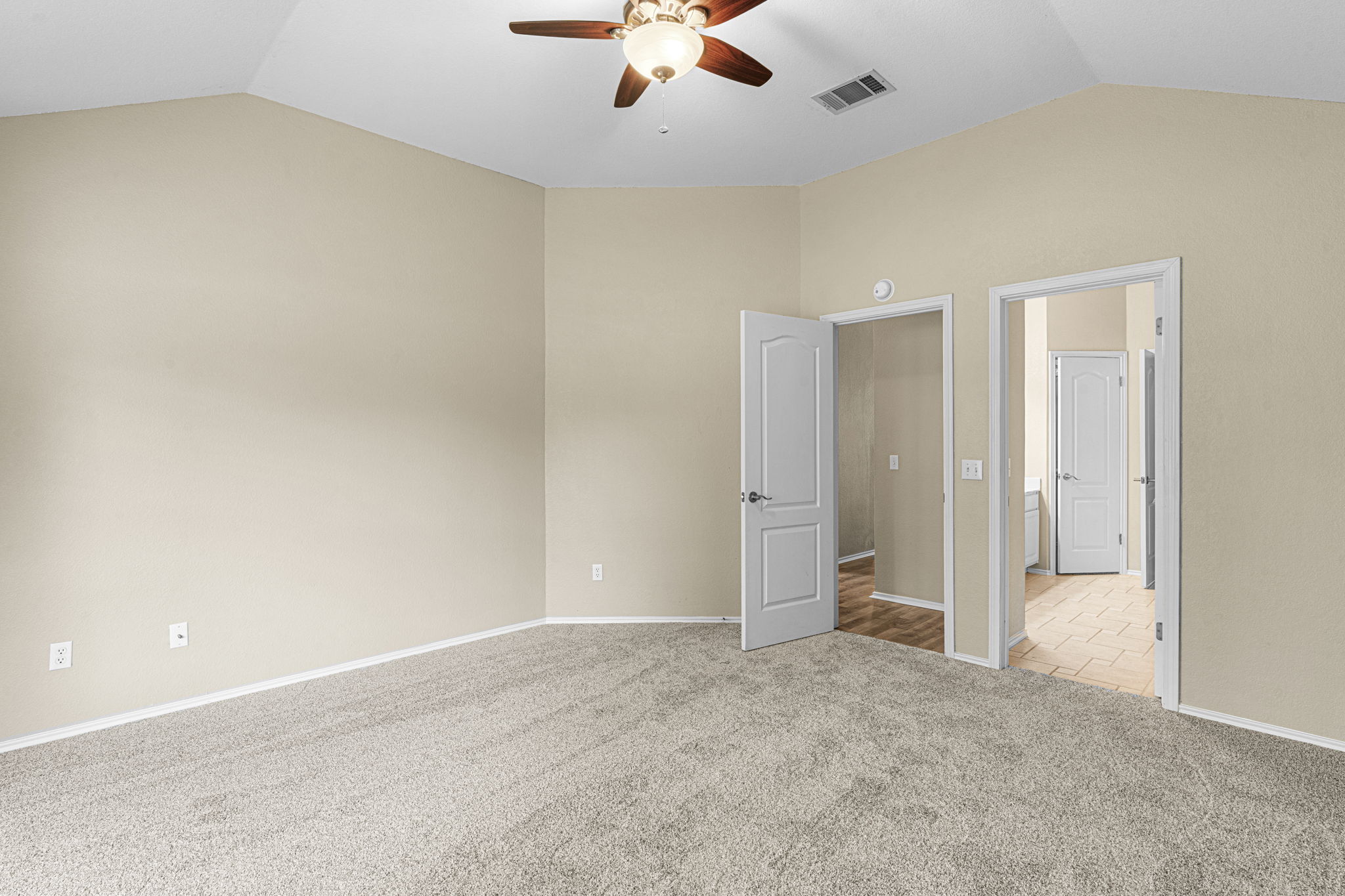 7172 Ridge Oak Road Austin, TX 78749 - Photo 30 of 40 A spacious bedroom features a vaulted ceiling, providing an airy and open atmosphere.