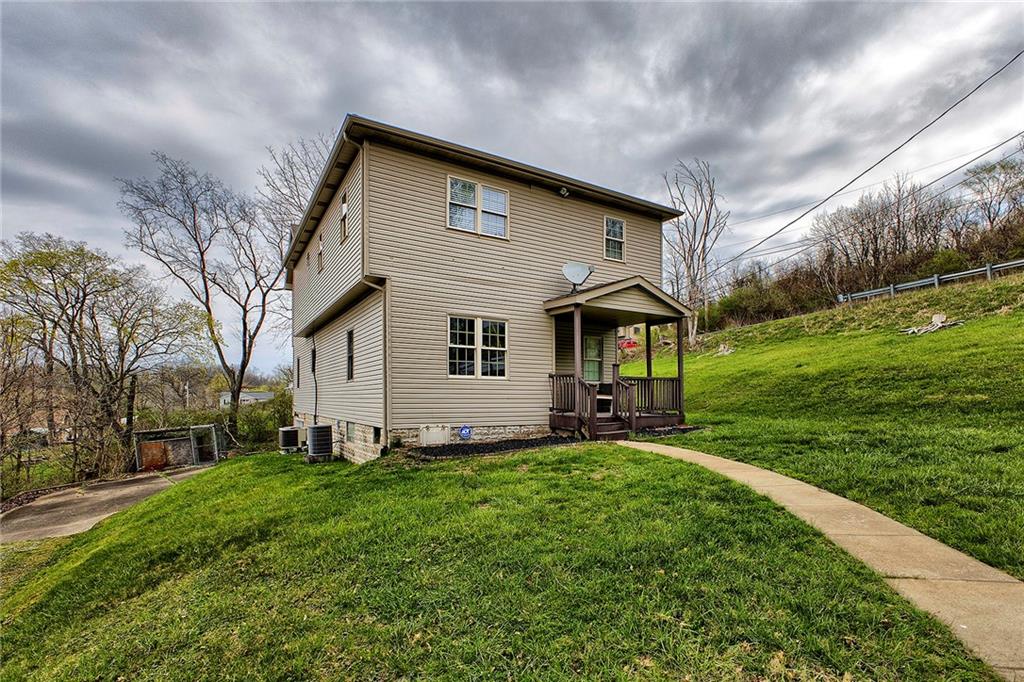 a front view of house with yard and green space