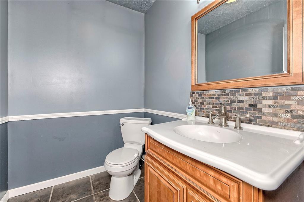 19 Lilly Lane Manor, PA 15665 - Photo 16 of 43 a bathroom with a sink a toilet and mirror