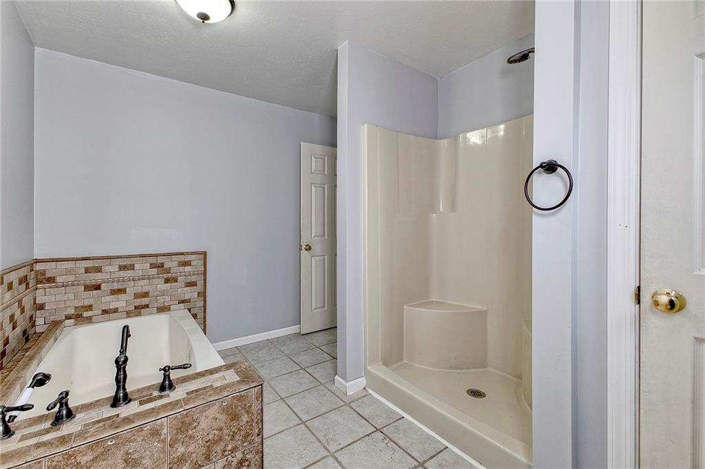 19 Lilly Lane Manor, PA 15665 - Photo 22 of 43 a bathroom with a tub and shower