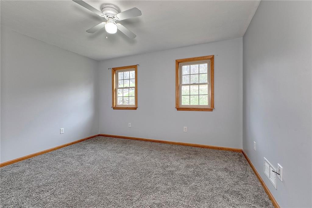 19 Lilly Lane Manor, PA 15665 - Photo 24 of 43 an empty room with windows and fan