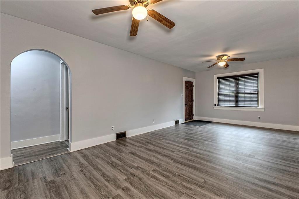 19 Lilly Lane Manor, PA 15665 - Photo 4 of 43 an empty room with wooden floor chandelier fan and windows