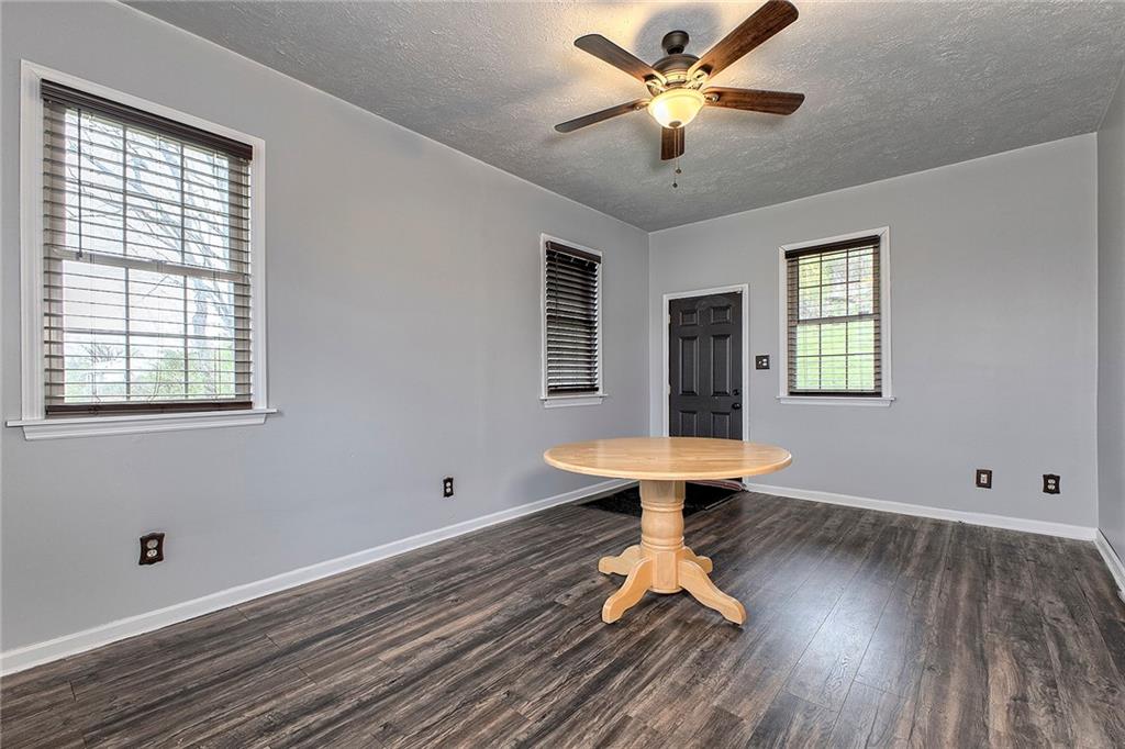 19 Lilly Lane Manor, PA 15665 - Photo 10 of 43 a view of a room with window ceiling fan and wooden floor