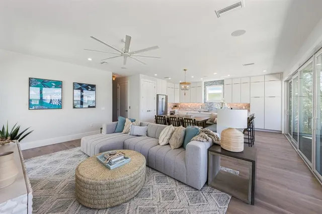 a kitchen with a sink stove cabinets and wooden floor