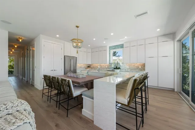 a kitchen with stainless steel appliances granite countertop a stove sink and cabinets